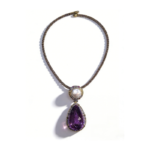 Luxury statement necklace featuring a 100 carat teardrop amethyst, freshwater non-nucleated pearl, and 925 sterling silver chain with diamond and ruby accents