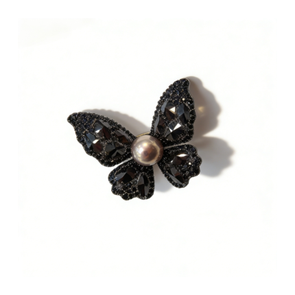 Luxury butterfly brooch with faceted obsidian crystal wings and a lustrous freshwater purple pearl centerpiece, set in a dark metal frame