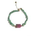 Natural emerald bead bracelet with watermelon tourmaline center stone and 18K gold clasp, worn on wrist
