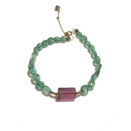 Natural emerald bead bracelet with watermelon tourmaline center stone and 18K gold clasp, worn on wrist